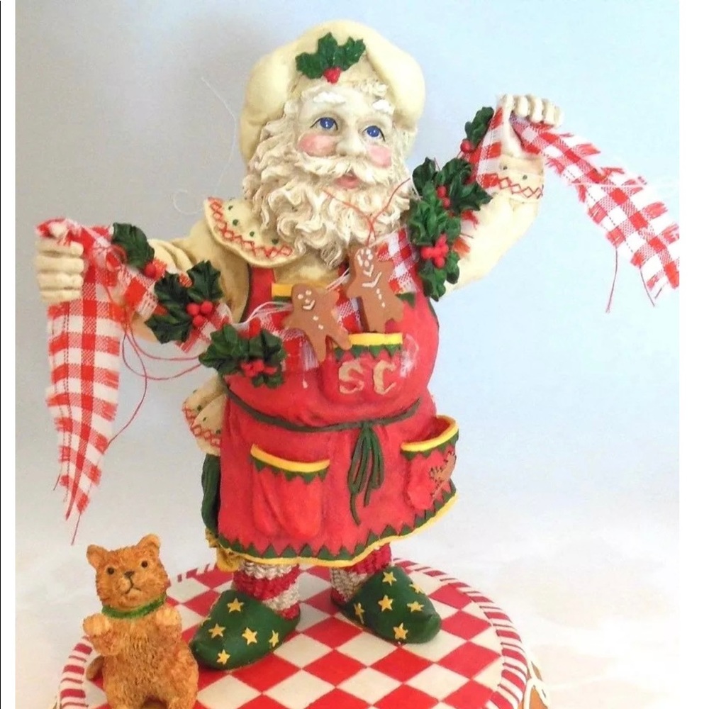 CHRISTMAS SANTA BAKER IN APRON HOLDING A RIBBON AND PLAYFUL CAT